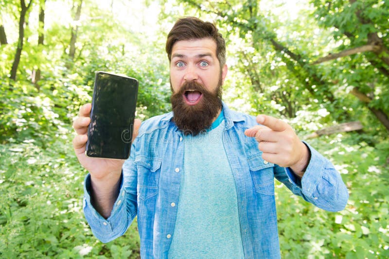 GPS and navigation apps. Useful program. Smartphone online navigation. Man bearded wanderer walking in forest with stock photography
