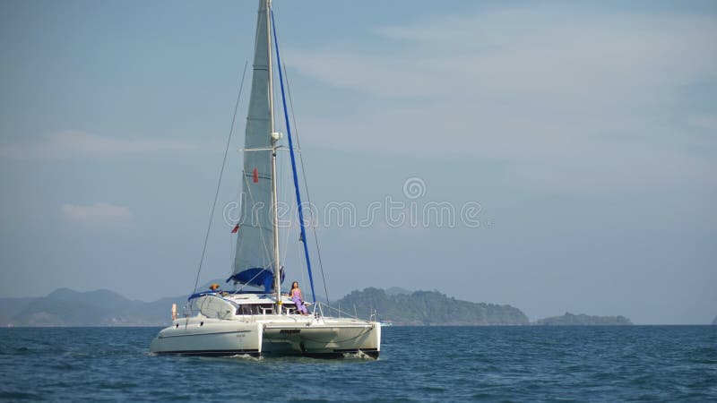 Graceful sailboat glide through blue turquoise calm water of sea. Tropical summer vacation dream. Yacht sailing on