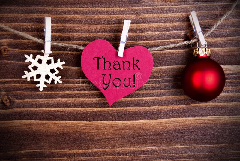 The Words Thank You on a Heart on a Line with Christmas Decoration or Winter Decoration. The Words Thank You on a Heart on a Line with Christmas Decoration or Winter Decoration