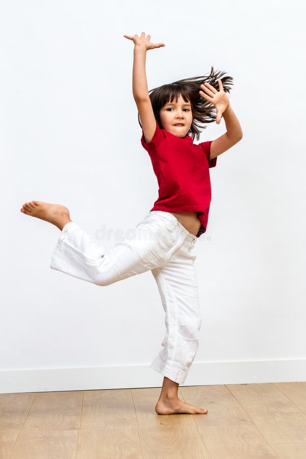 Gracious beautiful young girl dancing, showing joyous dynamic child movement. Gracious beautiful young girl with bare feet dancing, showing dynamic movement and royalty free stock photography Gracious beautiful young girl dancing, showing joyous dynamic child movement. Gracious beautiful young girl with bare feet dancing, showing dynamic movement and royalty free stock photography
