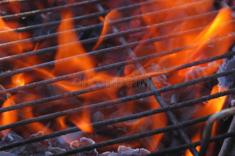 Just lighting the barbecue and the flames are coming up through the grill. Just lighting the barbecue and the flames are coming up through the grill