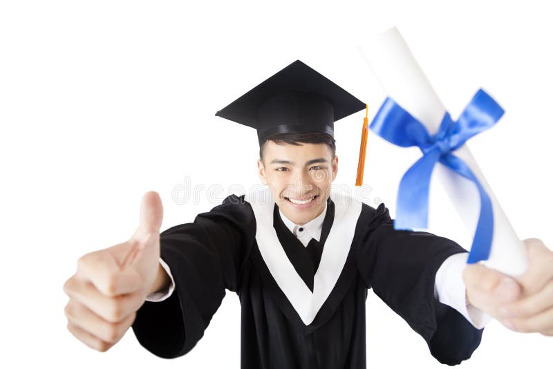 Graduado de faculdade masculino novo com polegar acima imagens de stock Graduado de faculdade masculino novo com polegar acima imagens de stock