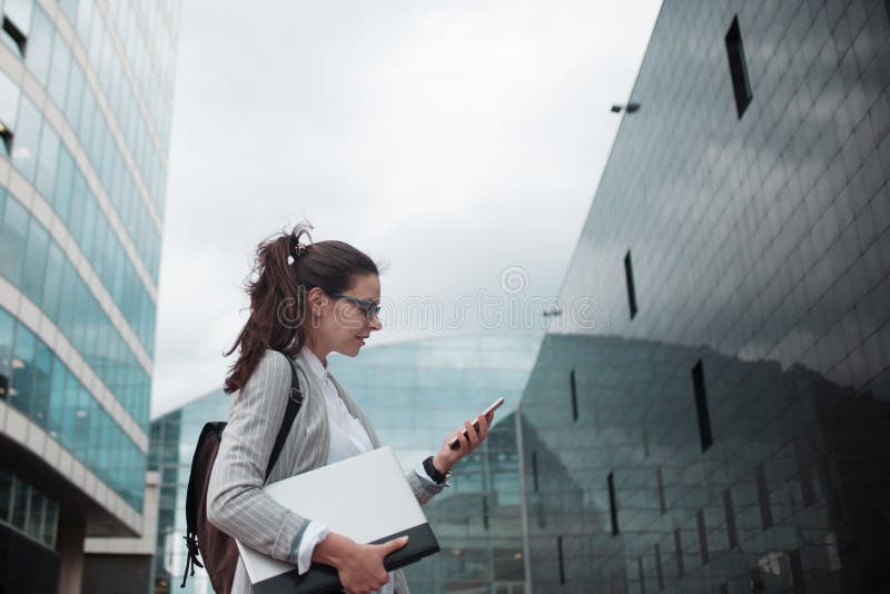 Graduate specialist comes to work in a large company. A young female Intern with a laptop and a telephone royalty free stock photography Graduate specialist comes to work in a large company. A young female Intern with a laptop and a telephone royalty free stock photography