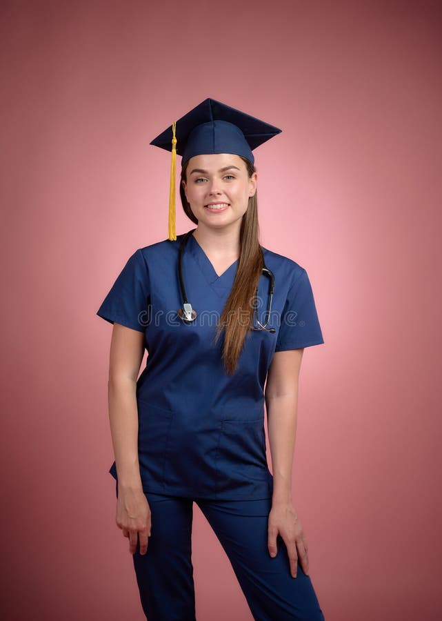 Graduated Nurse in Blue Uniform in Graduation Cap Standing, Looking