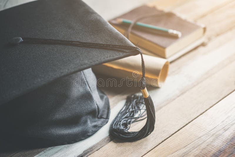 graduation cap, hat with degree paper on wood table graduation c