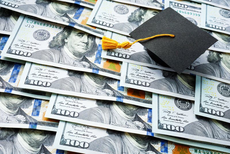 Graduation Cap on the Stack of Money. Student Loan Concept Stock Photo