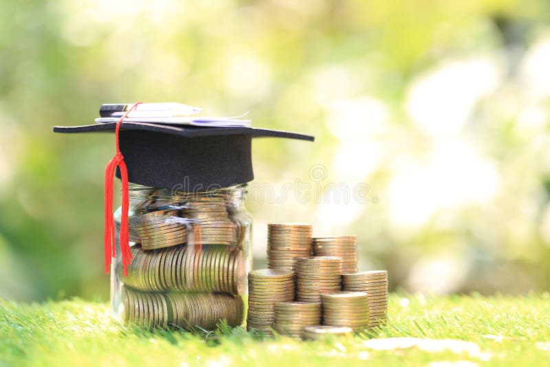 Graduation hat on the glass bottle with Stack of coins money on natural green background, Saving money for education concept