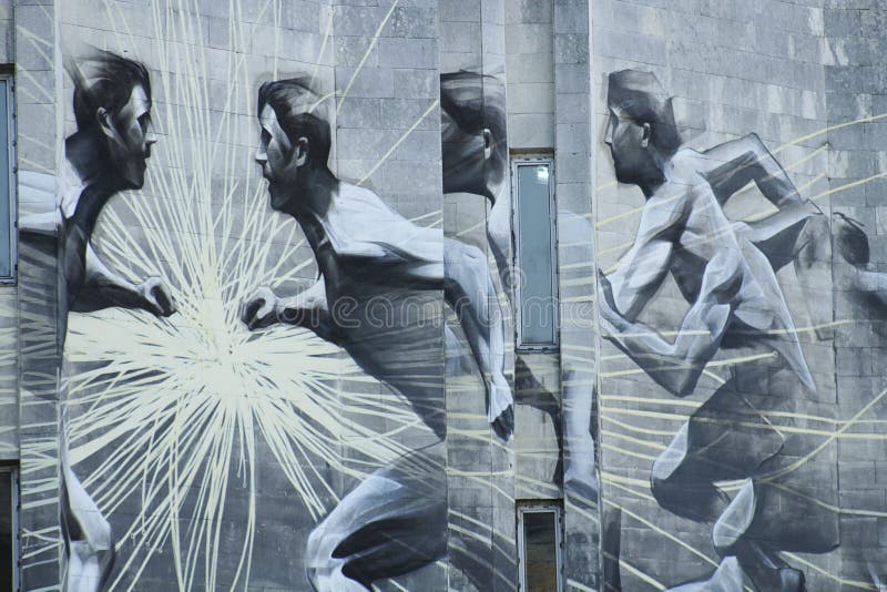 Graffiti athletes on the stone wall of building