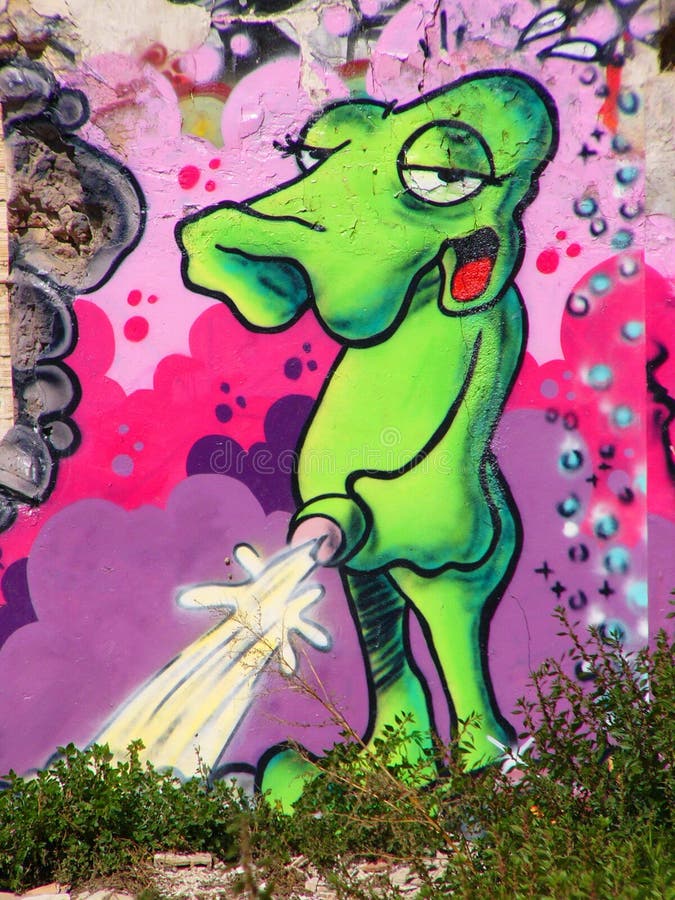 Green alien graffiti on a wall in Barcelona. Green alien graffiti on a wall in Barcelona.