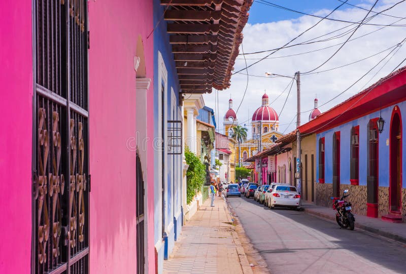 GRANADA, NICARAGUA, MAY, 14, 2018: Outdoor view of facade buildings with pink wall, wooden door and roof in a gorgeous