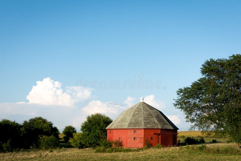 Granaio rosso rotondo unico circondato da terreno coltivabile aperto in Illinois rurale immagine stock libera da diritti
