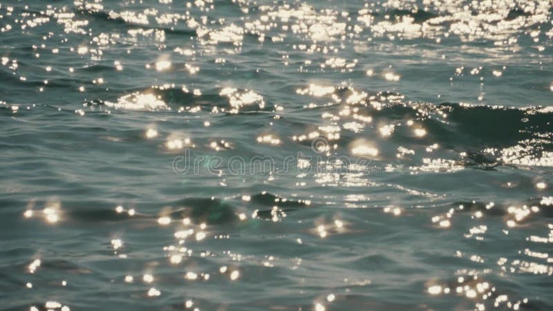 Granata di luce solare sulla superficie dell'acqua Riflessione della luce sulle onde del mare