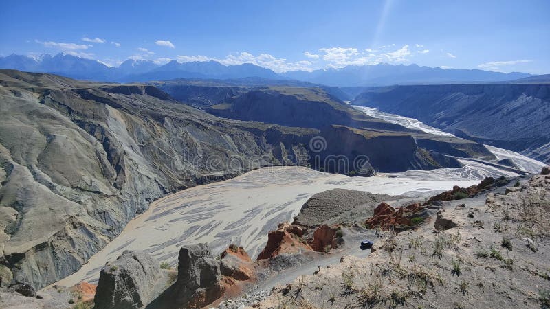 Grand canyon with running river and snow mountains royalty free stock images