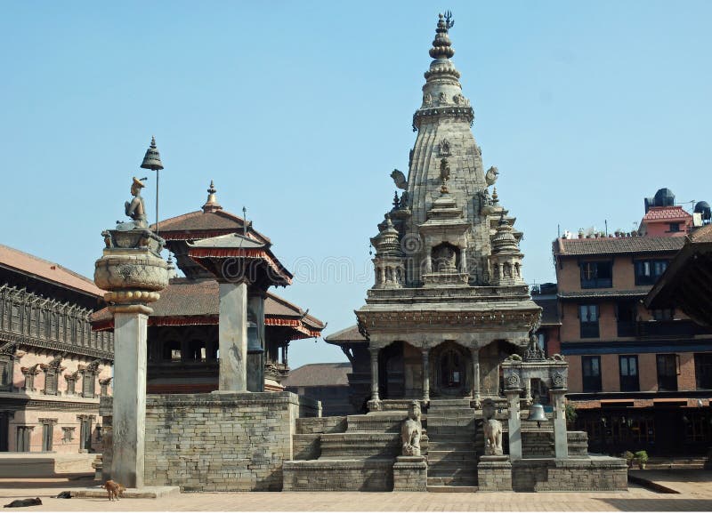 Durbar Square with Vatsala Durga Temple and bronze bell known as the bell-of barking dogs - The Palace of Fifty-five Windows - Statue of King Bhupatindra Malla - Bhaktapur - Nepal - World Heritage by UNESCO. Durbar Square with Vatsala Durga Temple and bronze bell known as the bell-of barking dogs - The Palace of Fifty-five Windows - Statue of King Bhupatindra Malla - Bhaktapur - Nepal - World Heritage by UNESCO
