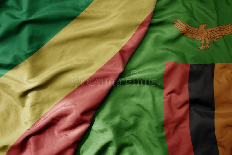 big waving national colorful flag of republic of the congo and national flag of zambia . macro. big waving national colorful flag of republic of the congo and national flag of zambia . macro