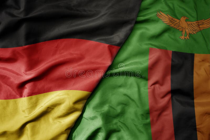 big waving realistic national colorful flag of germany and national flag of zambia . macro. big waving realistic national colorful flag of germany and national flag of zambia . macro