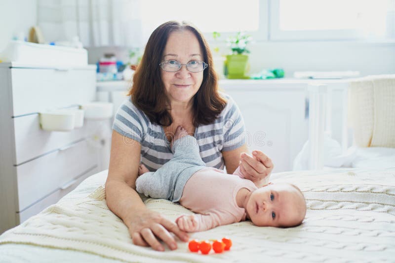 Grand-mère avec sa petite-fille nouveau-née adorable photo stock Grand-mère avec sa petite-fille nouveau-née adorable photo stock