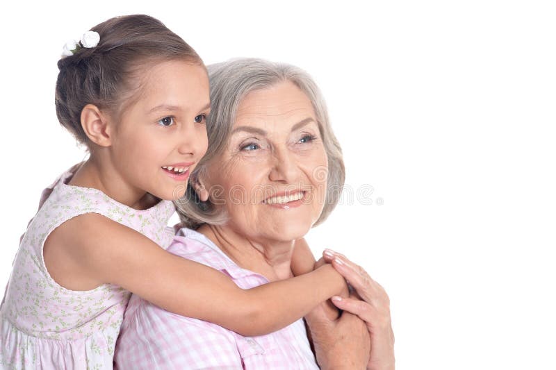Grand-mère et petite petite-fille sur le fond blanc photo stock Grand-mère et petite petite-fille sur le fond blanc photo stock