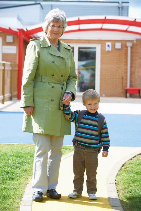 Grand-mère portant le petit-fils à l'école photographie stock libre de droits Grand-mère portant le petit-fils à l'école photographie stock libre de droits