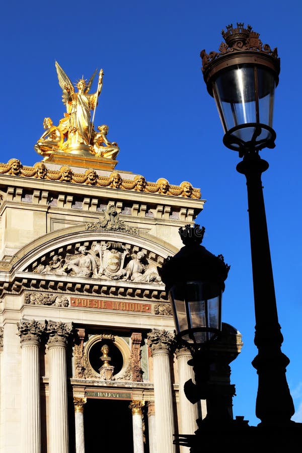 Grand Opera Paris Garnier golden statue and facade front view in front of old Lampposts france