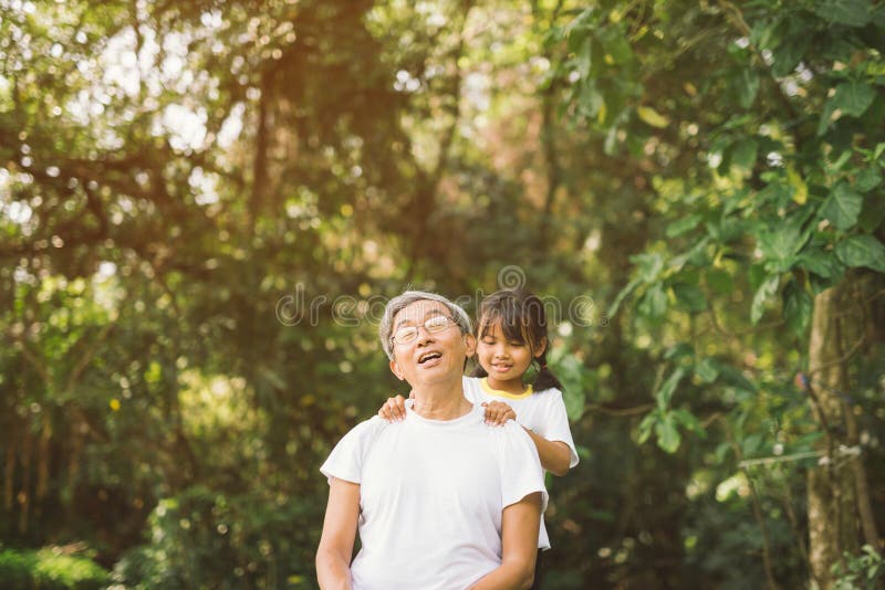 Grand-père curatif mignon de massage de petite fille photographie stock Grand-père curatif mignon de massage de petite fille photographie stock