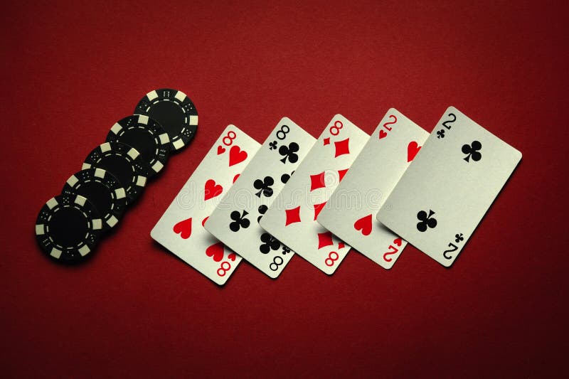 Great luck in the card game of poker with a winning combination of full house or full boat. Playing cards and chips are laid out in a club on a red table. Great luck in the card game of poker with a winning combination of full house or full boat. Playing cards and chips are laid out in a club on a red table.