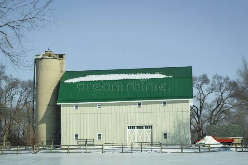 Grande grange verte blanche de toit avec le silo dans la neige d'hiver photographie stock