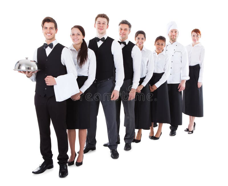 Grande grupo de garçons e de empregadas de mesa que estão na fileira foto de stock Grande grupo de garçons e de empregadas de mesa que estão na fileira foto de stock