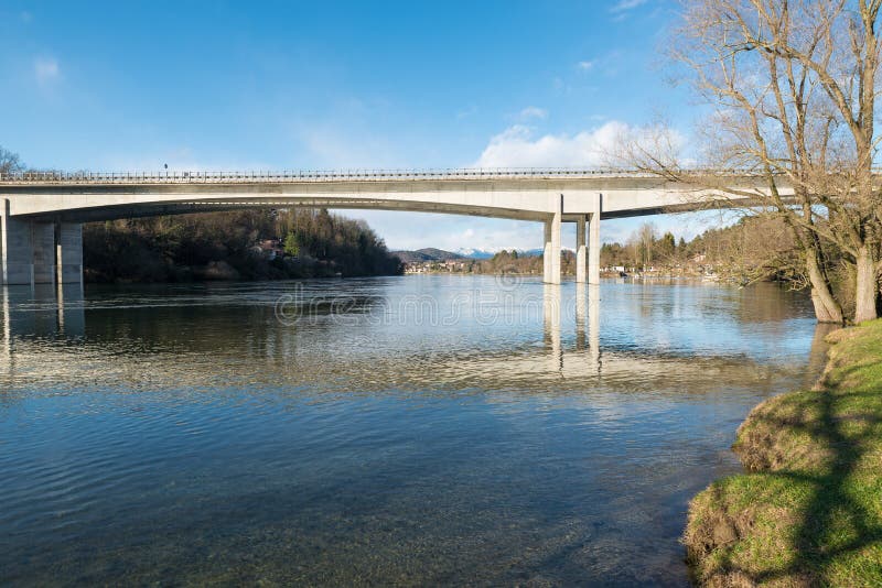 Ticino river and the motorway bridge A8 – A26 that connects the Lombardy region on the right with Piedmont. In the background the town of Sesto Calende, Italy. Ticino river and the motorway bridge A8 – A26 that connects the Lombardy region on the right with Piedmont. In the background the town of Sesto Calende, Italy