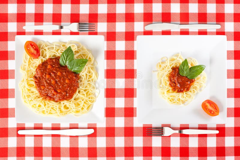 Contrasting large and tiny food portions of Spaghetti. Contrasting large and tiny food portions of Spaghetti