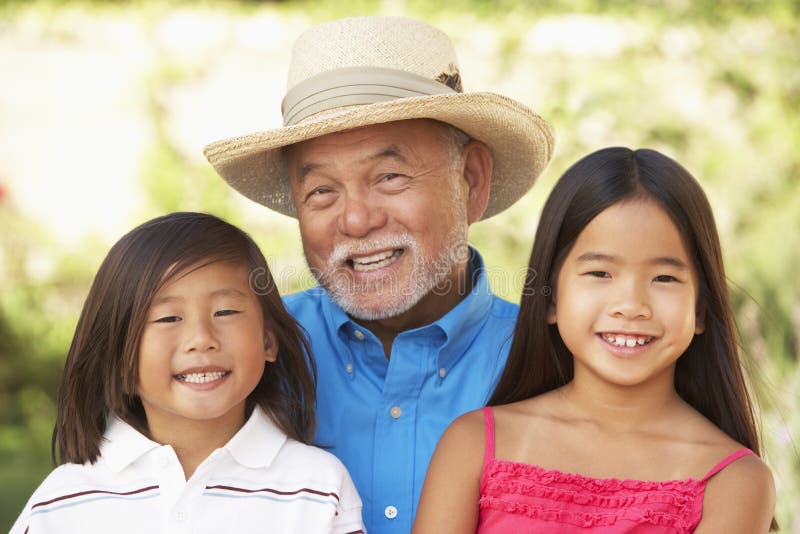 Grandfather With Grandchildren In Garden stock photo Grandfather With Grandchildren In Garden stock photo