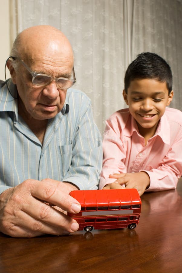 Grandfather and grandson sitting at the table