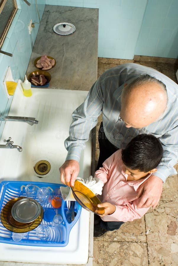 Grandfather and Grandson Wash Dishes. Close up - H stock images Grandfather and Grandson Wash Dishes. Close up - H stock images