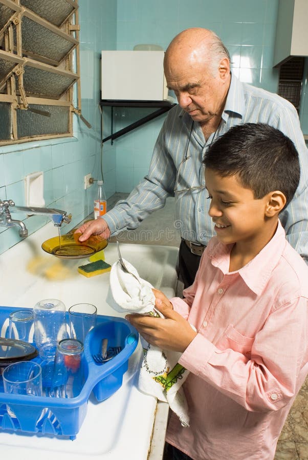 Grandfather and grandson washing dishes - Vertical royalty free stock photos Grandfather and grandson washing dishes - Vertical royalty free stock photos