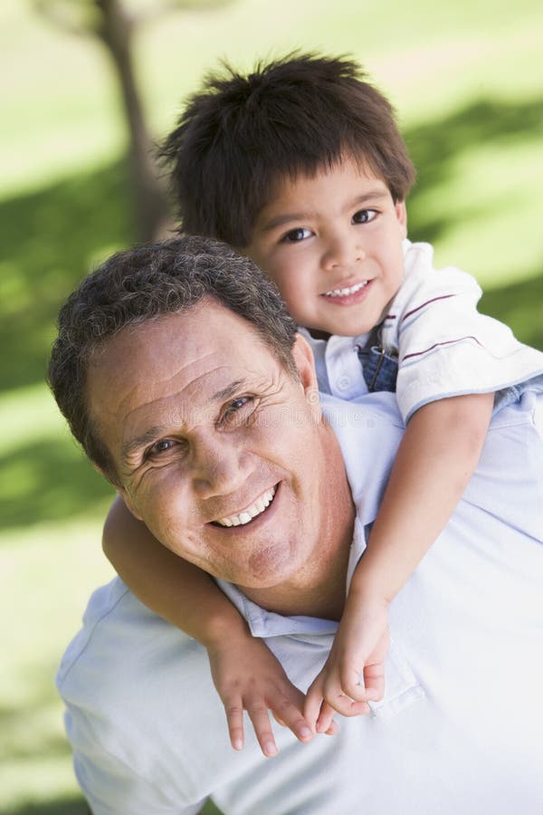 Grandfather piggyback riding grandson stock photo Grandfather piggyback riding grandson stock photo