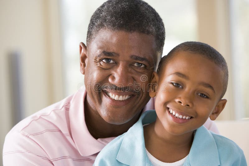 Grandfather and grandson indoors smiling. Grandfather and grandson indoors smiling.