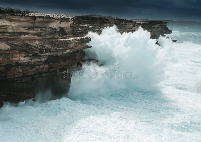 Large waves smash against the coast of Sydney creating large sprays of water forced upwards  which stand around 30 metres in height. Large waves smash against the coast of Sydney creating large sprays of water forced upwards  which stand around 30 metres in height