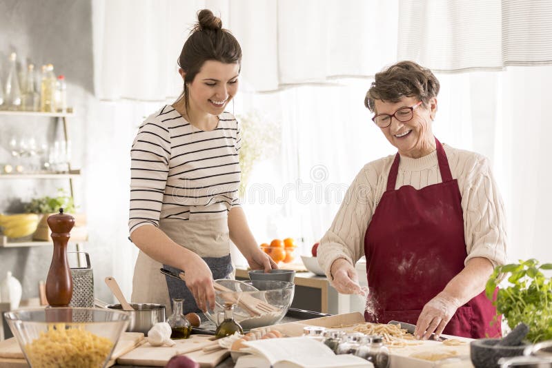 Grandma and granddaughter preparing dinner royalty free stock photos