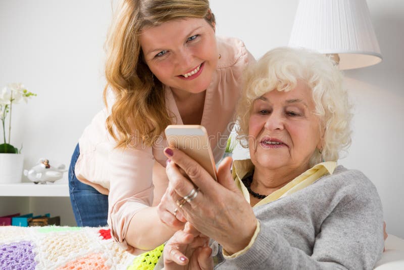 Grandma διδασκαλίας εγγονών πώς να χρησιμοποιήσει το έξυπνο τηλέφωνο στοκ φωτογραφίες Grandma διδασκαλίας εγγονών πώς να χρησιμοποιήσει το έξυπνο τηλέφωνο στοκ φωτογραφίες