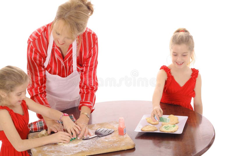 Grandmother decorating cookies with children