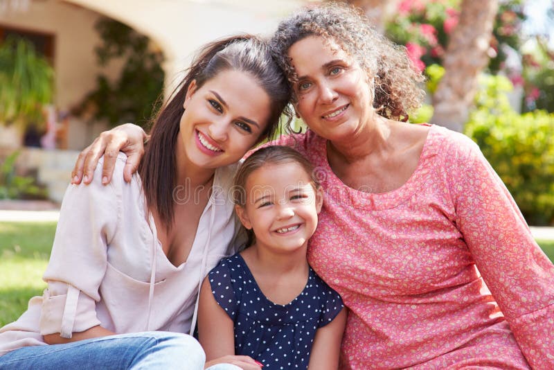 Grandmother In Garden With Daughter And Granddaughter Stock Photo