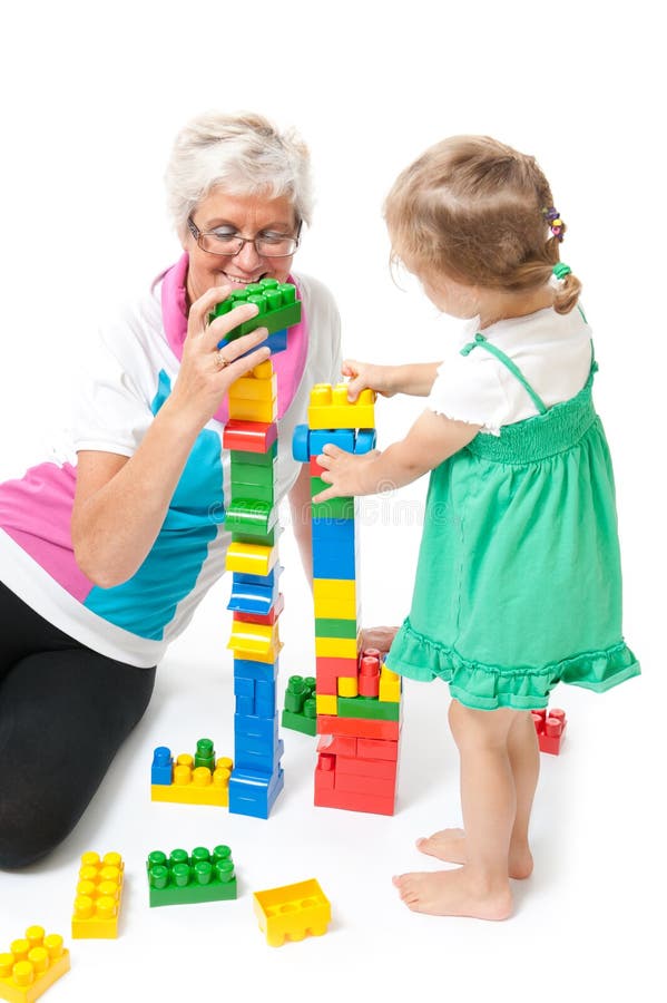 Grandmother with grandchildren playing with blocks