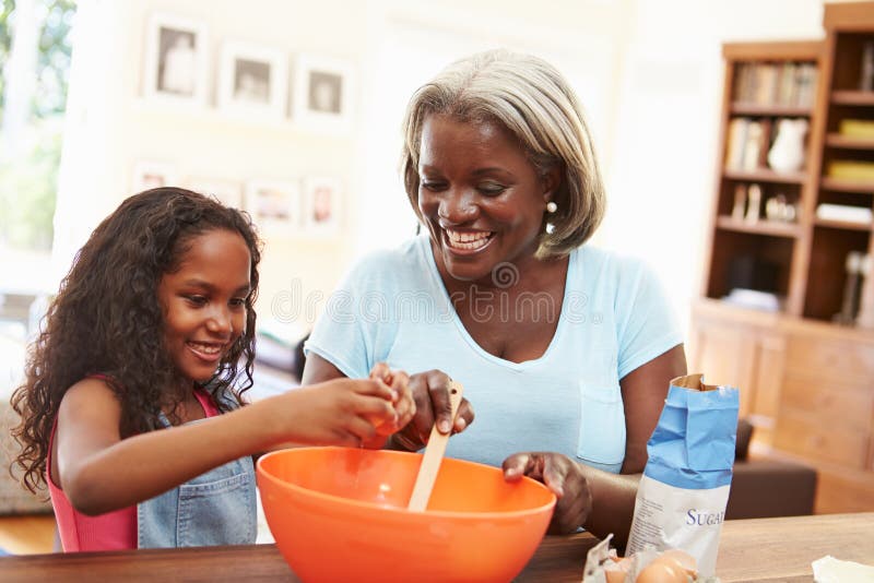 Grandmother And Granddaughter Baking Together At Home royalty free stock photography Grandmother And Granddaughter Baking Together At Home royalty free stock photography