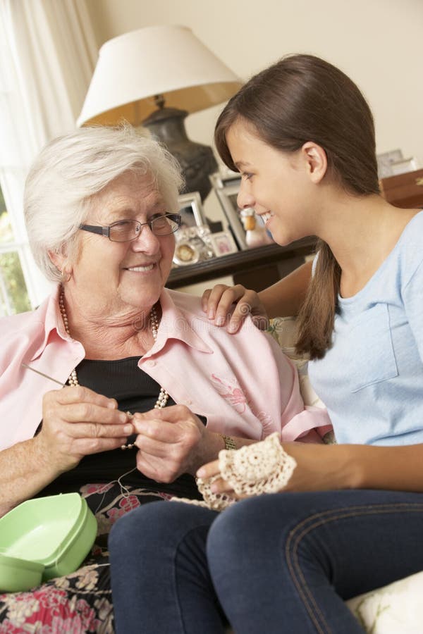 Grandmother Showing Granddaughter How To Crochet At Home