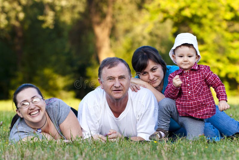 Grandpa, daughters and niece on grass