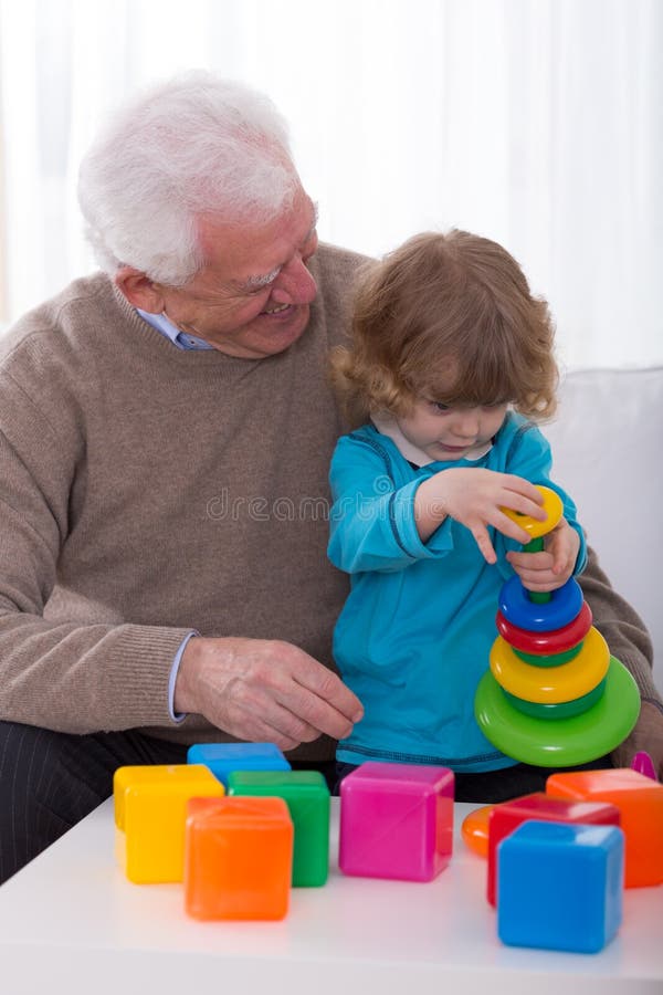 Grandpa and grandchild building tower