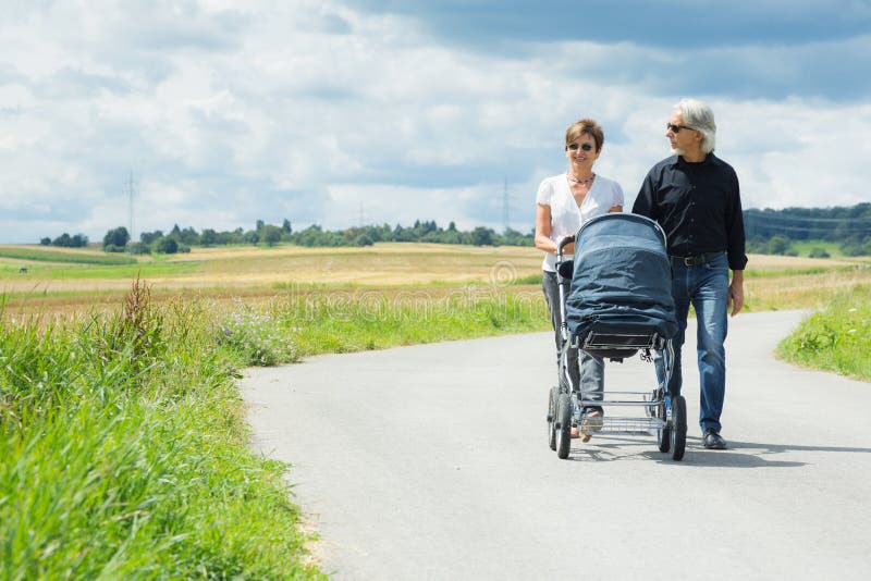 Grandparents Going For A Walk With Baby Stroller royalty free stock images Grandparents Going For A Walk With Baby Stroller royalty free stock images