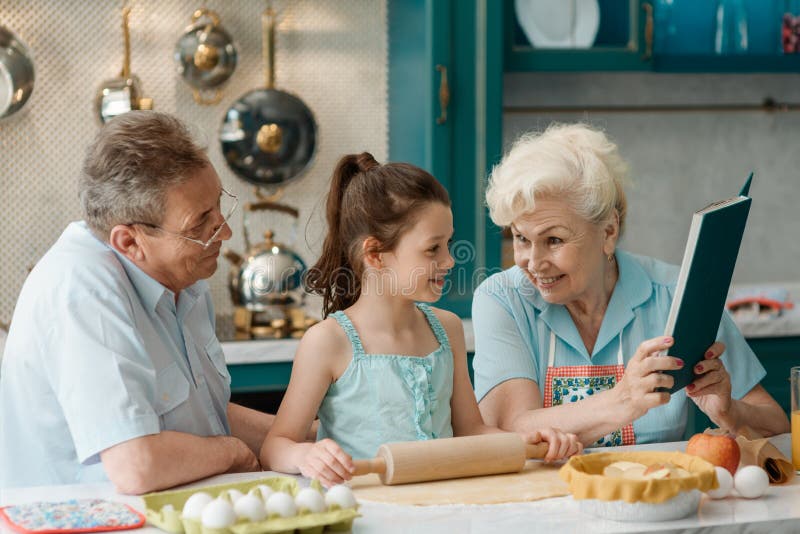 Grandparents teach granddaughter to bake stock images Grandparents teach granddaughter to bake stock images