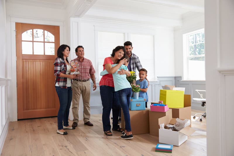 Grandparents Visiting Hispanic Family In New Home royalty free stock photography Grandparents Visiting Hispanic Family In New Home royalty free stock photography