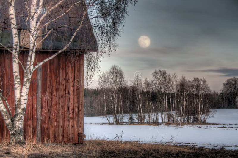 Old red barn in a countryside landscape with full moon. Old red barn in a countryside landscape with full moon